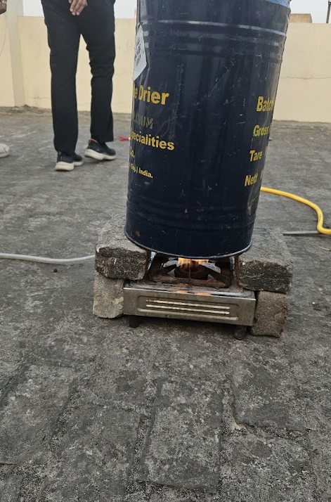 The recycled metal canister reactor sitting on a small stove on a rooftop