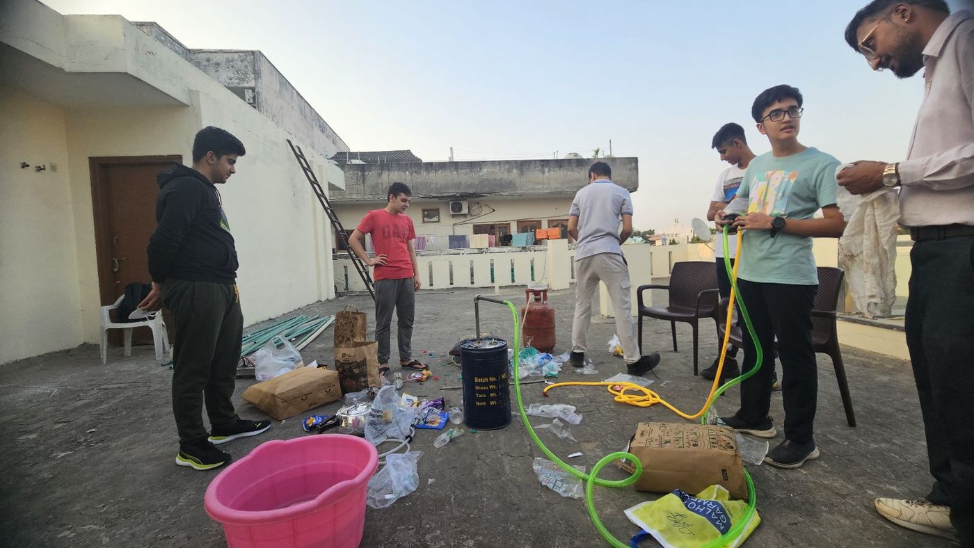 The team setting up the trial 2 rig on a rooftop, with the drum, hoses and a water bath